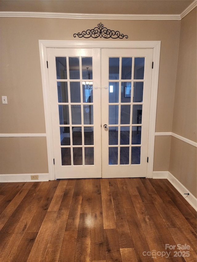 entryway featuring french doors, ornamental molding, and dark wood-type flooring