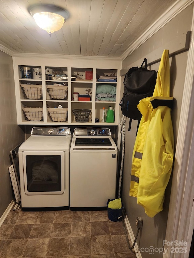 clothes washing area featuring washer and dryer and crown molding