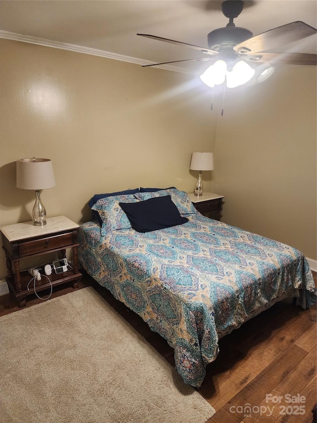 bedroom with ceiling fan and ornamental molding