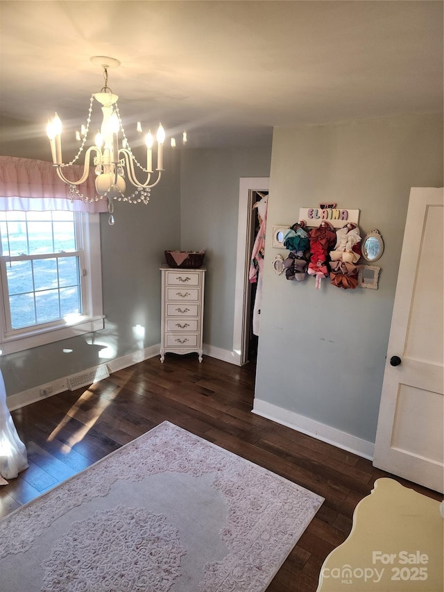 interior space featuring a chandelier and dark hardwood / wood-style floors