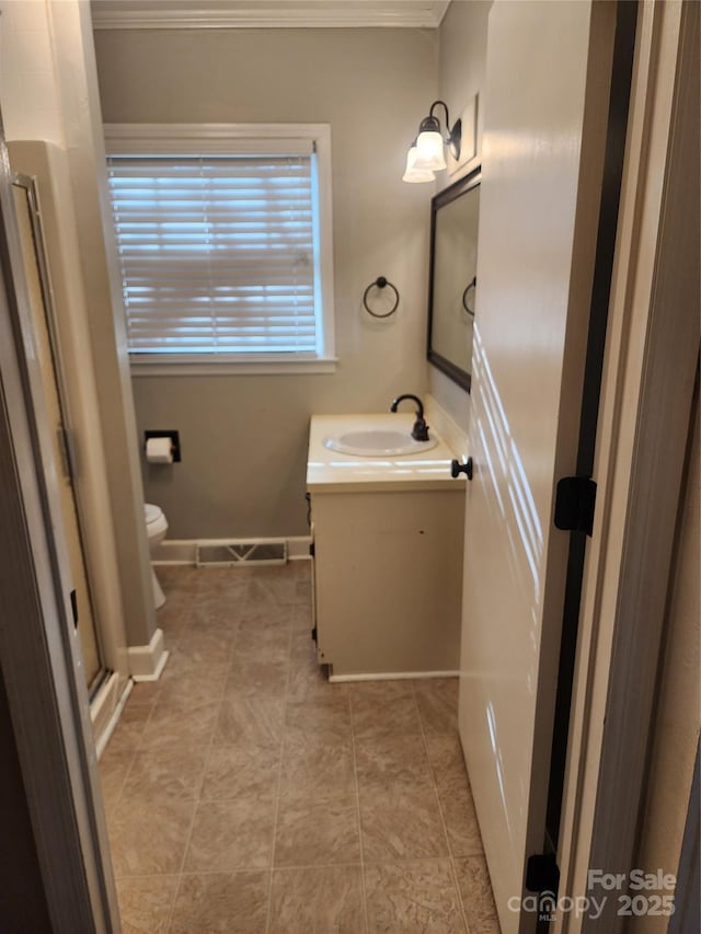 bathroom with tile patterned flooring, vanity, and toilet