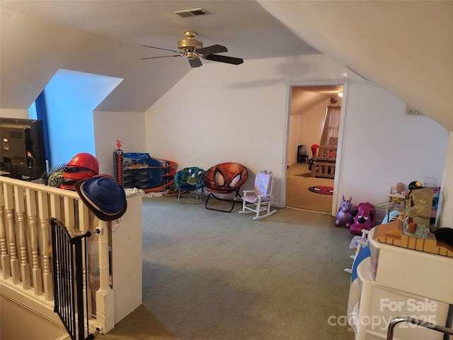 recreation room with carpet flooring, vaulted ceiling, and ceiling fan