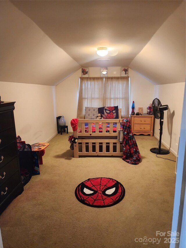 carpeted bedroom with lofted ceiling