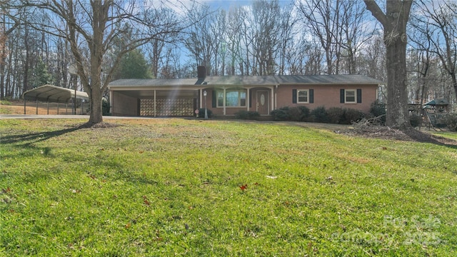 ranch-style home featuring a carport and a front lawn