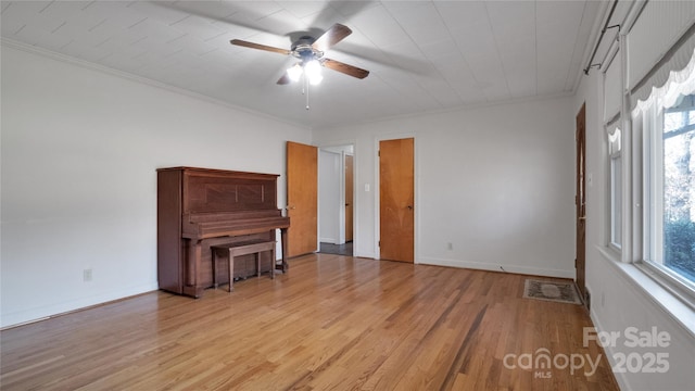 interior space with light hardwood / wood-style floors, ceiling fan, and crown molding