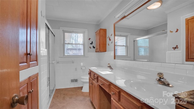 bathroom with walk in shower, vanity, crown molding, tile walls, and toilet