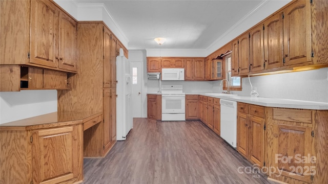 kitchen with white appliances, dark hardwood / wood-style floors, ornamental molding, and sink