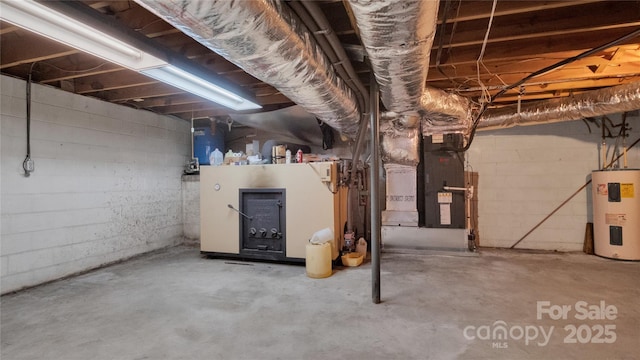 basement featuring heating unit and water heater