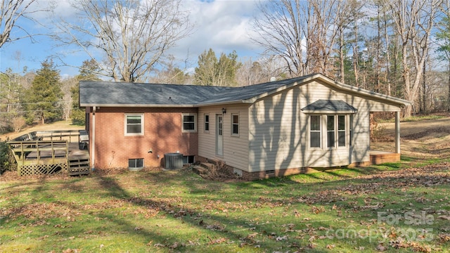 view of property exterior featuring central AC, a deck, and a lawn