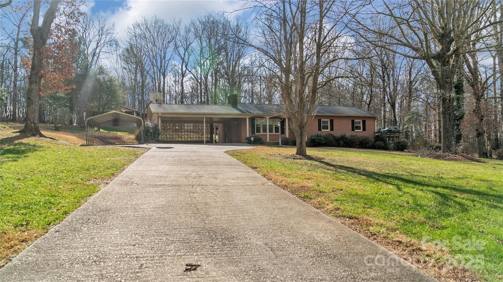 ranch-style home with a carport and a front lawn