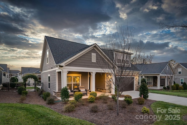 craftsman house with a porch and a garage