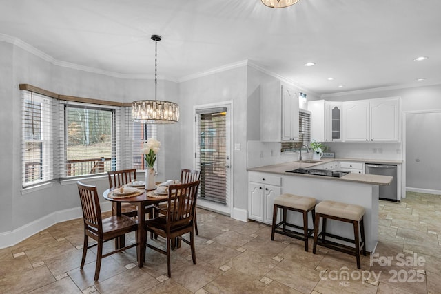 dining space featuring crown molding, an inviting chandelier, and sink