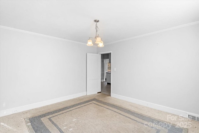 empty room featuring a chandelier and crown molding