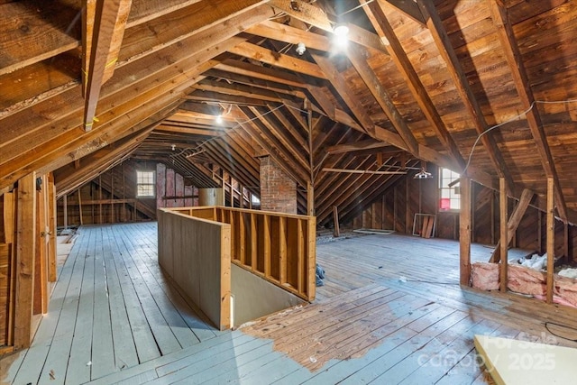 unfinished attic featuring a healthy amount of sunlight