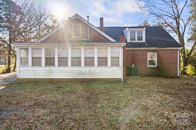 rear view of house with a sunroom and central AC unit