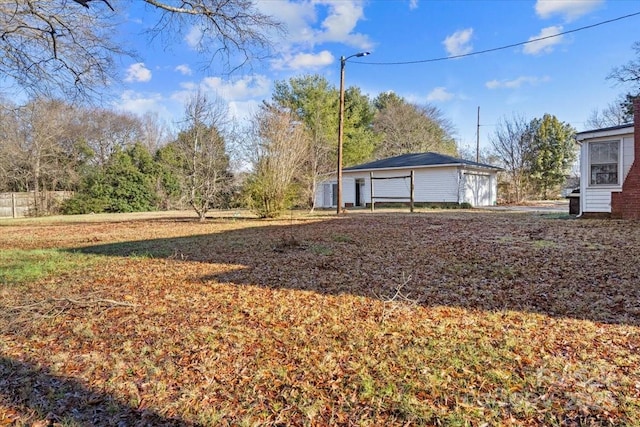 view of yard featuring an outbuilding and a garage