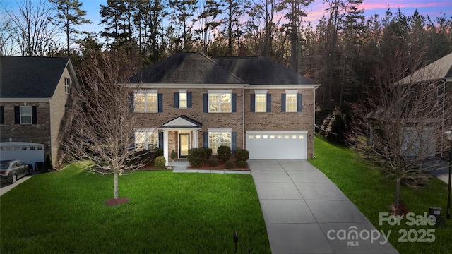 view of front of house with a lawn and a garage