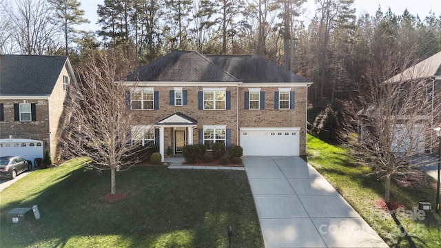 view of front of property featuring a front lawn and a garage