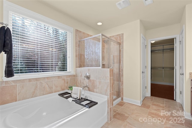 bathroom featuring separate shower and tub and tile patterned floors