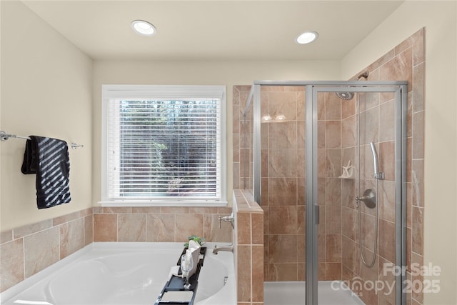 bathroom featuring independent shower and bath