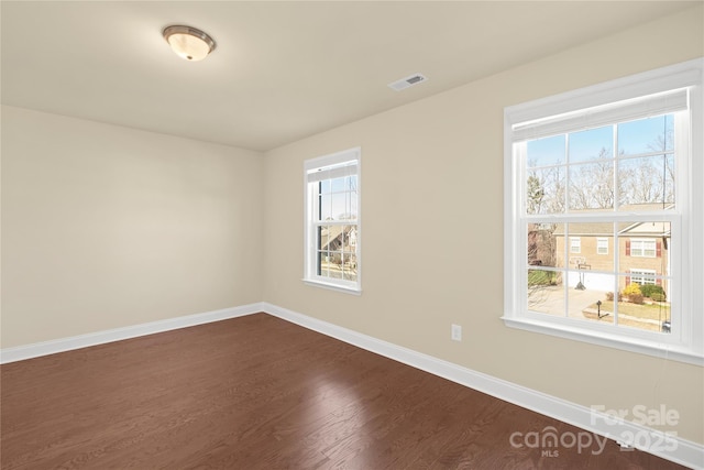 unfurnished room featuring dark hardwood / wood-style floors