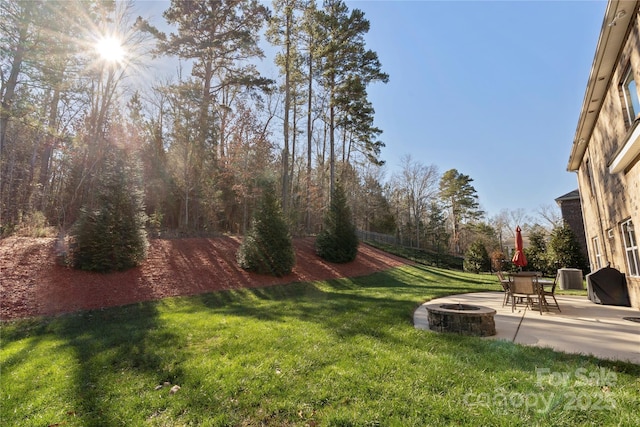 view of yard with an outdoor fire pit and a patio