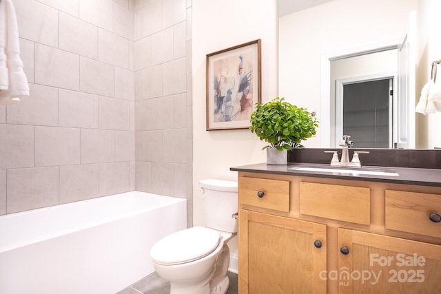 full bathroom featuring tiled shower / bath combo, vanity, and toilet