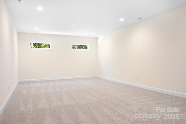 unfurnished room featuring light carpet