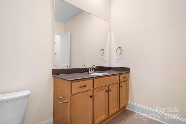 bathroom featuring tile patterned flooring, vanity, and toilet