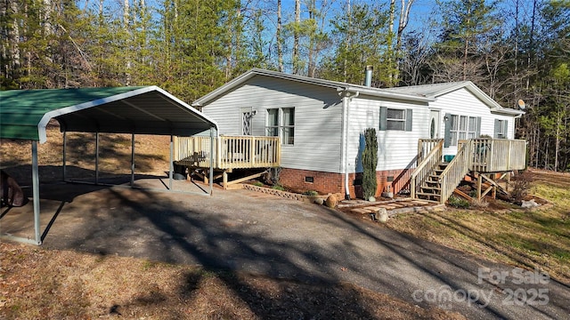 back of property with a carport and a deck