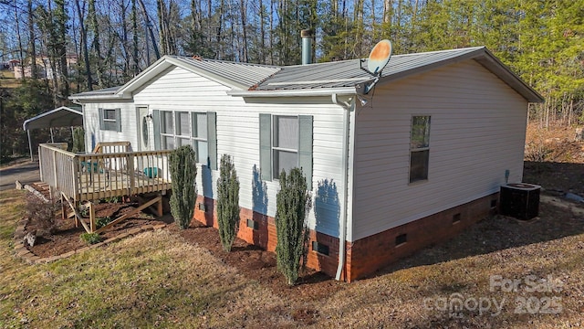 exterior space featuring a carport, a wooden deck, and central AC