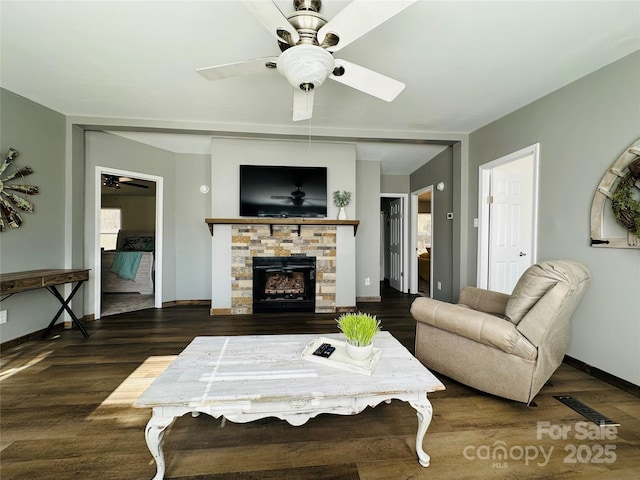 living room featuring a fireplace and dark wood-type flooring