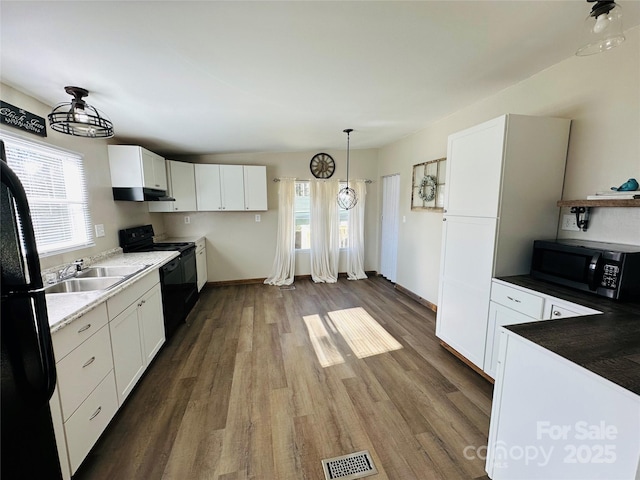 kitchen featuring white cabinets, dark hardwood / wood-style flooring, sink, and black appliances