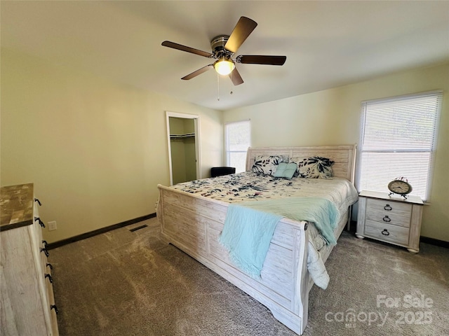 carpeted bedroom with a walk in closet, a closet, ceiling fan, and lofted ceiling