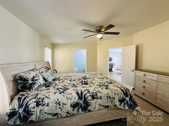 bedroom featuring ensuite bath, ceiling fan, and carpet floors