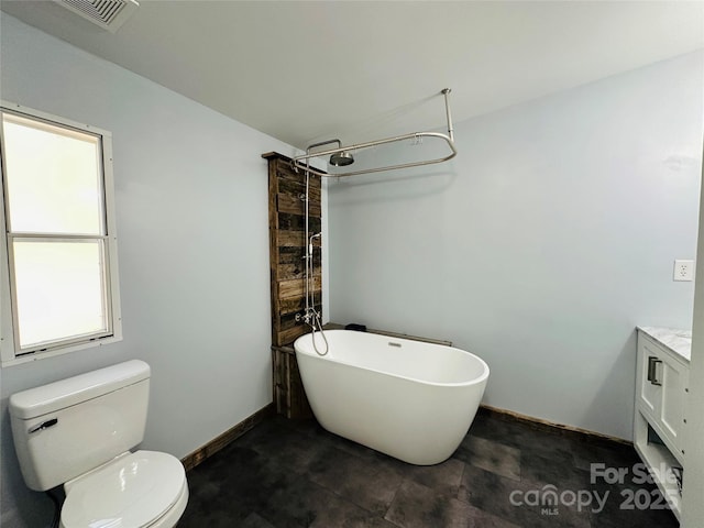 bathroom with vanity, toilet, and a tub to relax in