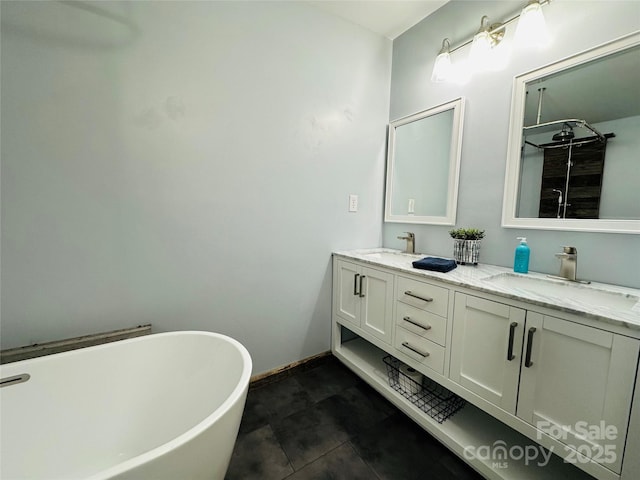 bathroom featuring a washtub, vanity, and tile patterned flooring