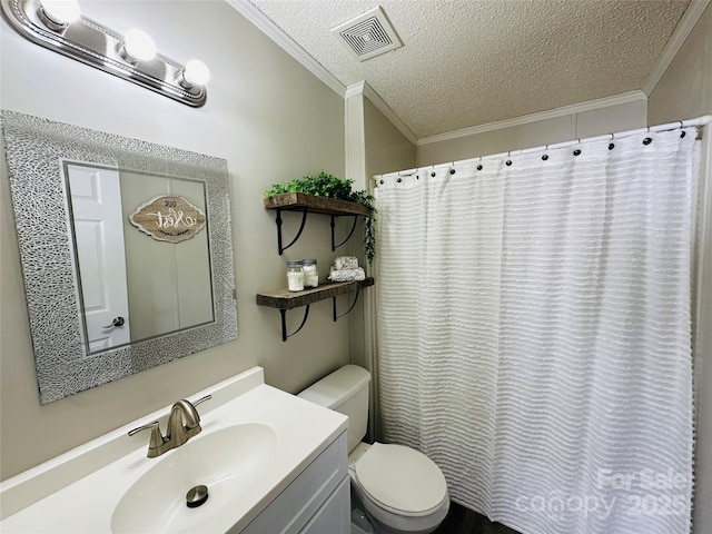 bathroom with vanity, toilet, ornamental molding, and a textured ceiling