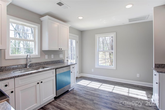 kitchen featuring sink, stainless steel dishwasher, white cabinets, and light stone counters