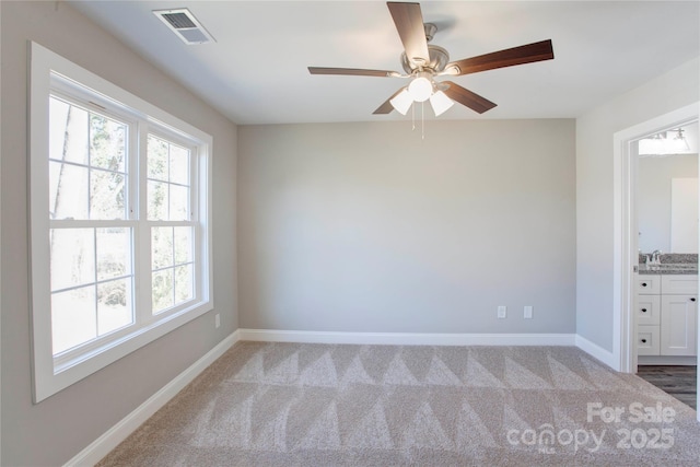 unfurnished room featuring light carpet