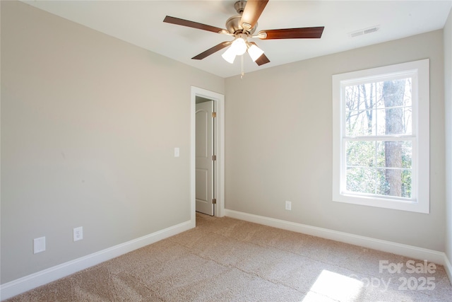 carpeted spare room with ceiling fan