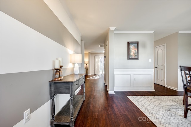 hallway with dark hardwood / wood-style flooring and ornamental molding