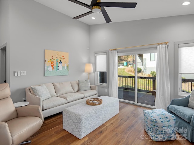 living room with dark hardwood / wood-style floors and ceiling fan