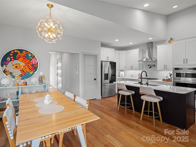 dining room featuring light hardwood / wood-style flooring, a chandelier, and sink