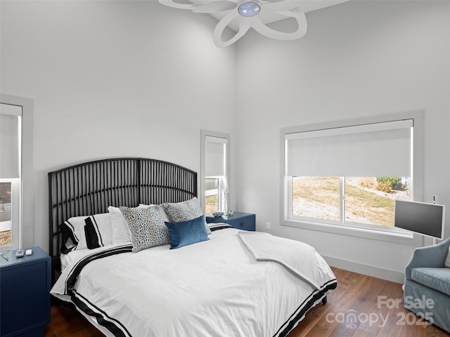 bedroom featuring ceiling fan and dark wood-type flooring