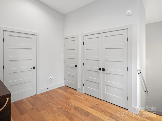 unfurnished bedroom featuring light hardwood / wood-style floors and a closet