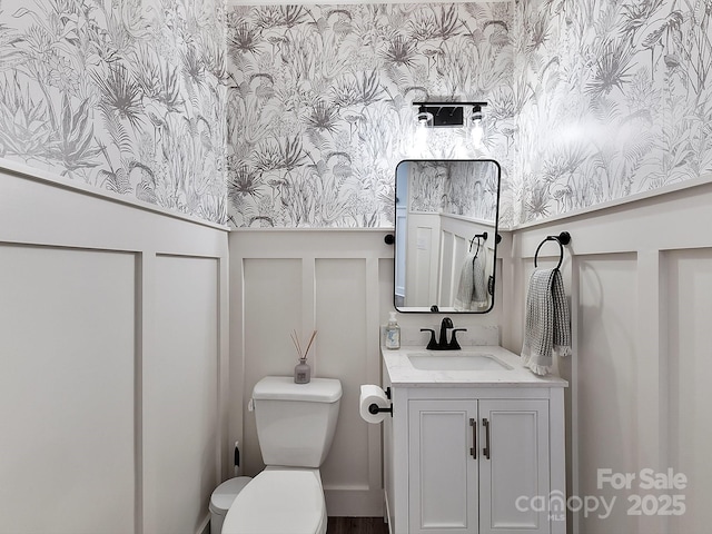 bathroom featuring vanity and toilet