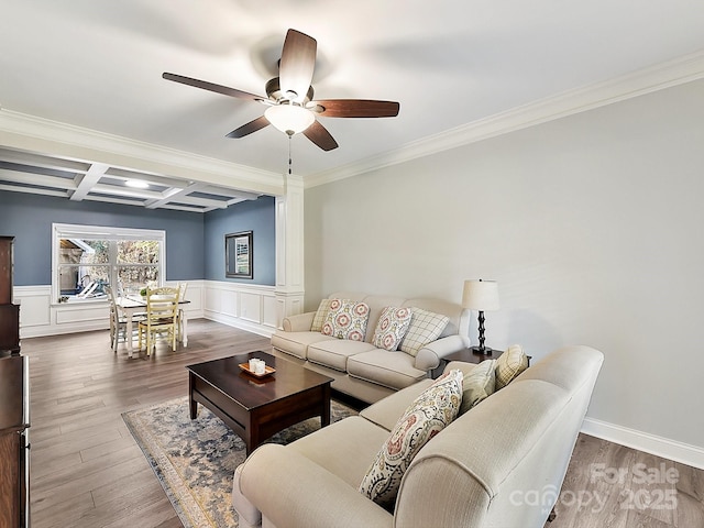 living room featuring beam ceiling, coffered ceiling, decorative columns, hardwood / wood-style floors, and ornamental molding