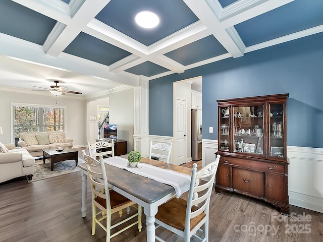 dining area featuring ceiling fan, beamed ceiling, coffered ceiling, and ornamental molding