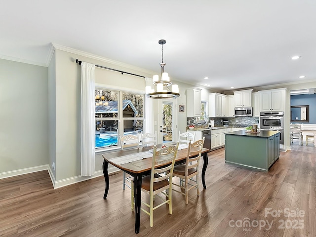 dining space with a chandelier, dark hardwood / wood-style flooring, and ornamental molding